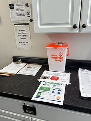Battery Recyling Bucket Photo of Battery Bucket on table in ReUseIt Room