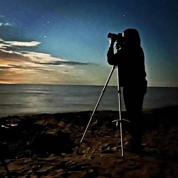 Photo of person taking a picture of night sky