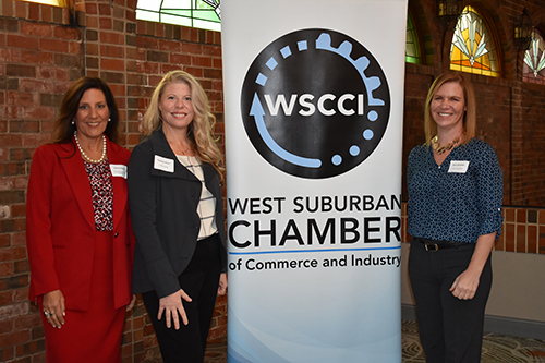 Photo of Business Staff in front of West Suburban Chamber Banner