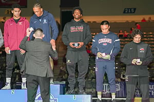 Wrestling Athletes on Podium receiving awards