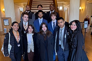Students posing in front of Staircase