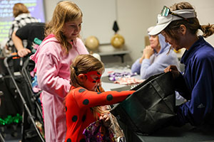 Kids in costumes at Trunk or Treat handing out candy to kids