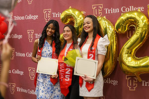 Photo of Graduates holding diplomas