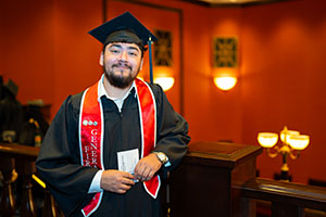Photo of Graduate leaning on stair railing