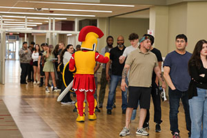 Photo of Troy the Mascot greeting Honor Students
