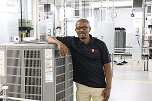 Photo of HVAC Instructor posing with a cooling unit