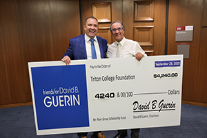 Photo of Mayor Guerin with Tom Olson posing with giant check