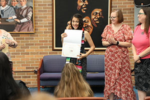Photo of student holding diploma