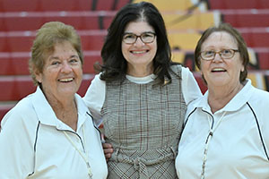 Photo of President Moore with Volleyball Coaches