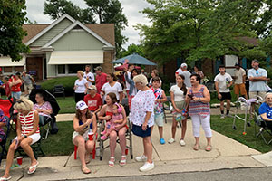 Photo of viewers standing on curb waiting for parade