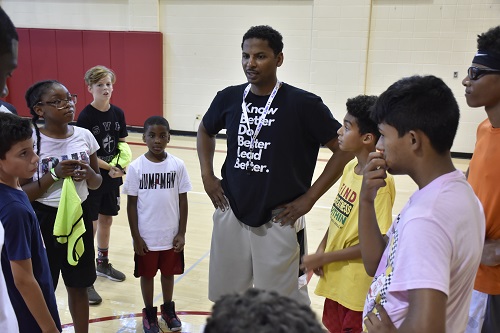 Pictured: Triton College alumni Andre Lodree (center) launched Four Point Play, Inc. basketball camps in 2013. 