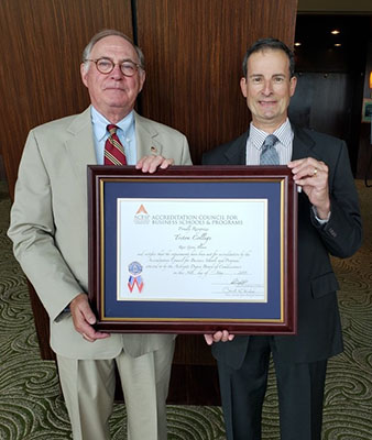Dr. Griffin and Professor Hiller with Accreditation Award